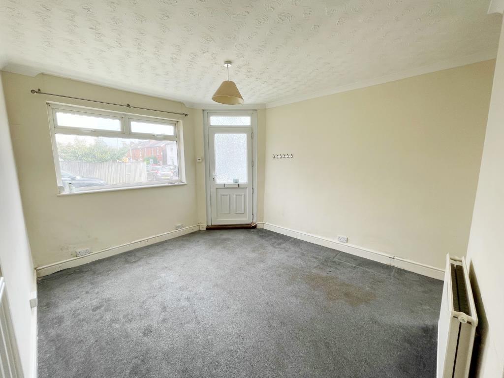 Lot: 10 - TWO-BEDROOM MAISONETTE - Living room with beige walls and grey carpet